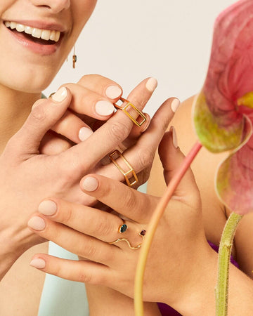 Two girls trying on LÚDERE I Can & I Will Rings