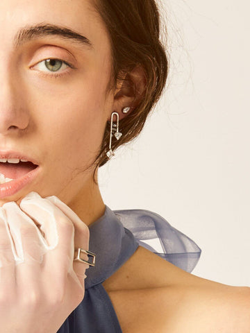 A girl wear the LÚDERE On My Way To Wonderland earrings in sterling silver with white topaz gemstones