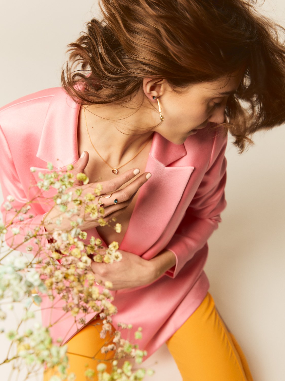 Ludere Jewelry, Alex in pink jacket and yellow pants with flowers, earrings, necklace