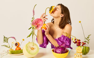 Ludere Jewelry Main Hero Image, a girl with artful flowers & fruits, rings, earrings, necklaces, sunflowers, melons, oranges